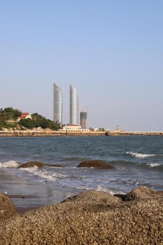 a view of the ocean with buildings in the background at City Hotel Xiamen-Free Welcome Fruits in Xiamen