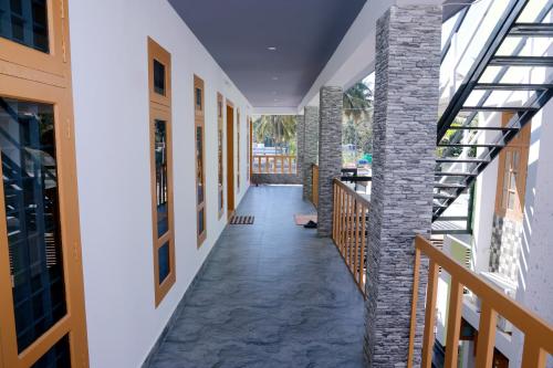 an internal corridor of a building with a glass ceiling at Oxygen Home Stay in Agali