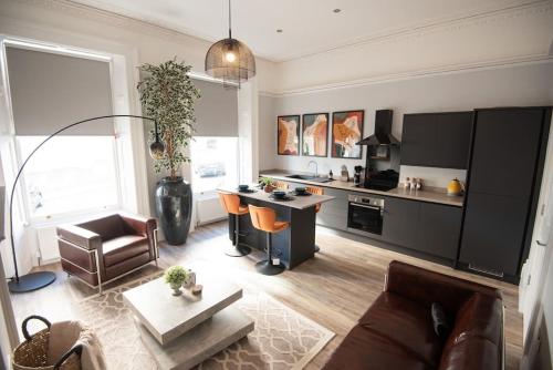 a living room with a couch and a table at Stunning City Apartment in the Heart of Plymouth in Plymouth