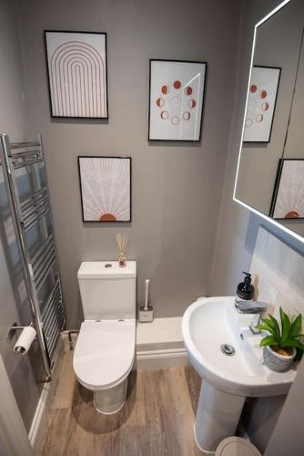 a bathroom with a white toilet and a sink at Stunning City Apartment in the Heart of Plymouth in Plymouth