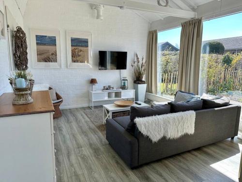 a living room with a couch and a table at Boerenslag 41 in Sint Maartensvlotbrug