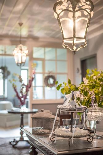 a table with a chandelier and flowers on it at "Apeiros Chora" Hotel, Zagori in Kato Pedina