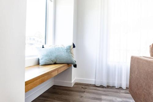 a pillow sitting on a window sill in a room at Discover - Ebenezer Bicheno in Bicheno