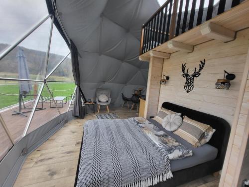 a bedroom in a igloo with a bed in it at Glamping nad Sanem in Krzemienna