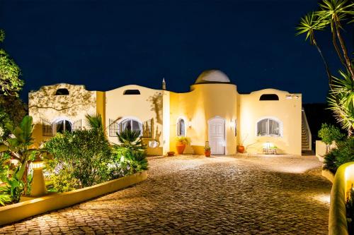 a large white building with a courtyard at night at Casa Lusitania 19 in Faro