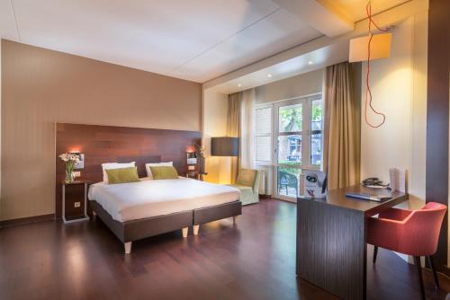 Postel nebo postele na pokoji v ubytování Golden Tulip Ampt van Nijkerk