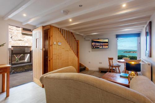 a living room with a couch and a table at Bijou Bolthole in Mousehole