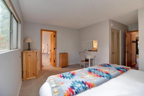 a bedroom with a large bed and a table at Fourth Sisters Escape in Sisters