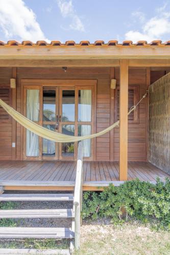 a wooden house with a yellow ribbon on the porch at Villa Mango in Icaraí