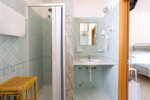 a bathroom with a sink and a shower at Hotel Bolivar in Marina di Camerota