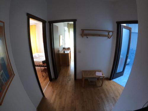 a hallway with two mirrors and a room with a bed at Escape Express by PortofinoVacanze in Rapallo