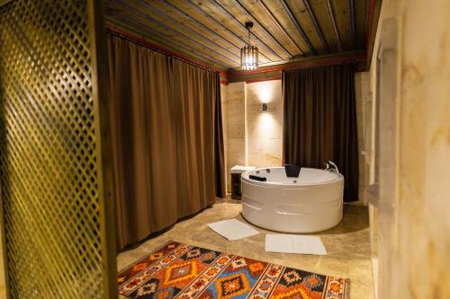 a bathroom with a large tub and a shower at Uçhisar Premium in Nevsehir