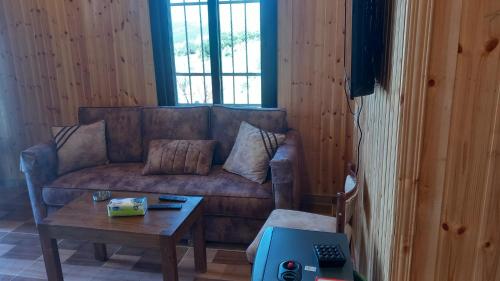 a living room with a couch and a coffee table at Rosemary Huts in Ajloun