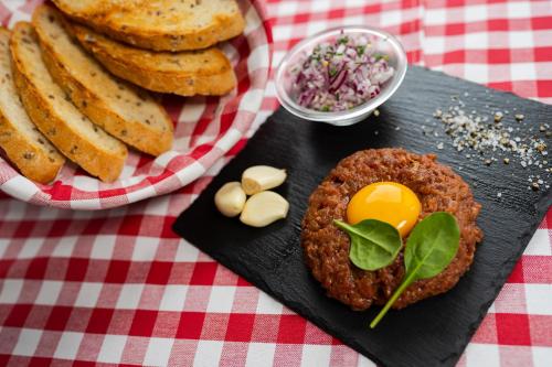 a plate of food with bread and eggs on a table at Hotel Strachanovka - Jánska Koliba in Liptovský Ján