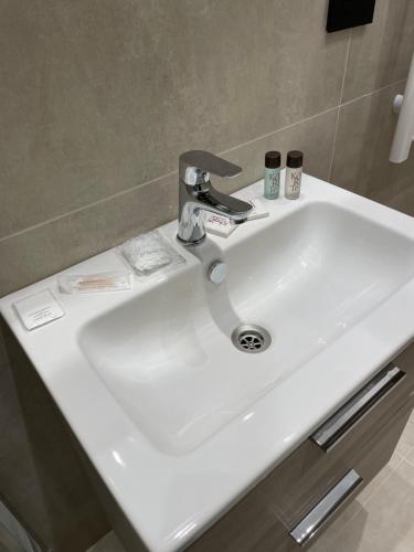 a white bathroom sink with a faucet on it at B&B Grace's Home Affittacamere in Canicattì