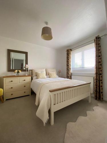 a bedroom with a large white bed and a mirror at ROSE COTTAGE in Ryde