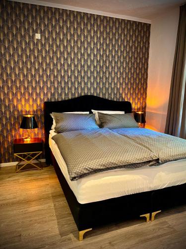 a bedroom with a large bed with a wall at Pension Winnemuller in Cochem