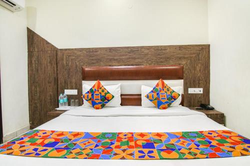 a bedroom with a bed with a colorful comforter at FabHotel La Vista in Zirakpur