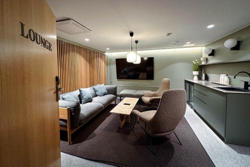 a living room with a couch and a table at Original Sokos Hotel Valjus Kajaani in Kajaani