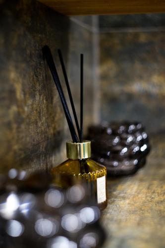 a bottle with sticks in it sitting on a table at Apartament Tatarska Przemyśl in Przemyśl