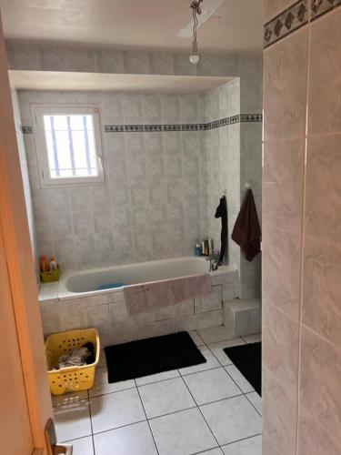 une salle de bain avec une baignoire et une fenêtre dans l'établissement Studio t1 rustique, à Clichy