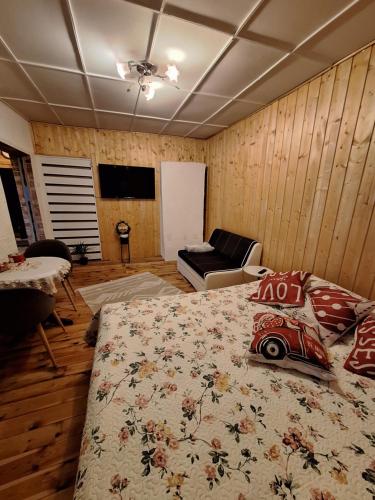 a bedroom with a bed and a couch at Ziedu aleja in Sigulda