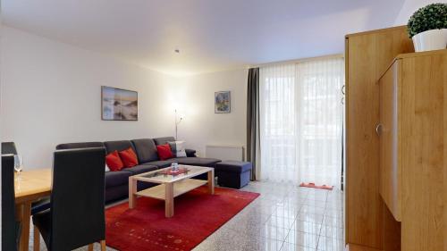 a living room with a couch and a table at strandnahe FeWo mit Schwimmbad im Haus, a cappella 68,Binz in Binz