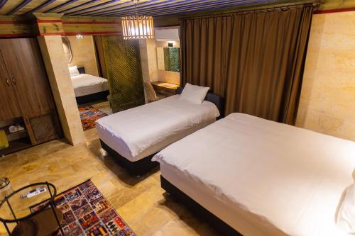 a hotel room with two beds and a bedroom at Uçhisar Premium in Nevsehir