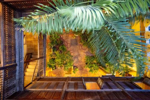 a room with a bunch of plants on a wall at Jafferji House in Zanzibar City