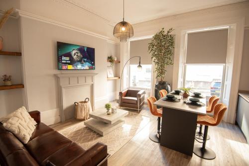 a living room with a couch and a table at Stunning City Apartment in the Heart of Plymouth in Plymouth