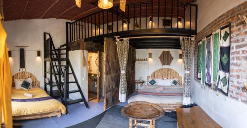a bedroom with two bunk beds and a ladder at Plum Eco House in Sapa