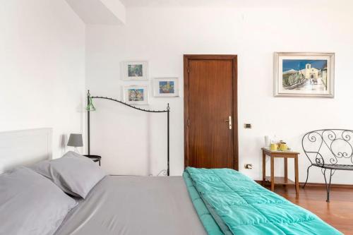 a bedroom with a bed and a wooden door at Isola Bella - Rooms il Pescatore in Taormina