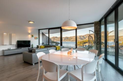 a dining room and living room with a white table and chairs at Korcula Luxury Apartments in Korčula