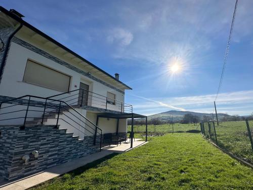 a house with stairs and a view of a field at Apartamentos La casa del Zapatero in Corvera