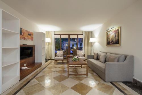 a living room with a couch and a table at Nirvana Mediterranean Excellence - Ultra All Inclusive in Beldibi