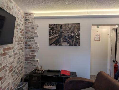 a room with a brick wall with a picture on the wall at Burghaus-Cochem in Cochem