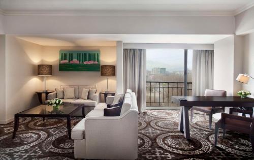 a living room with a couch and a table at Hyatt Regency Bishkek in Bishkek