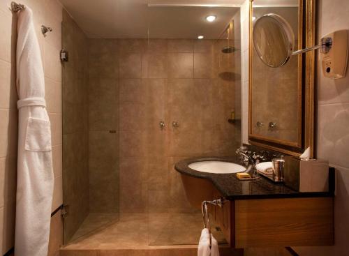 a bathroom with a sink and a shower at Hyatt Regency Bishkek in Bishkek