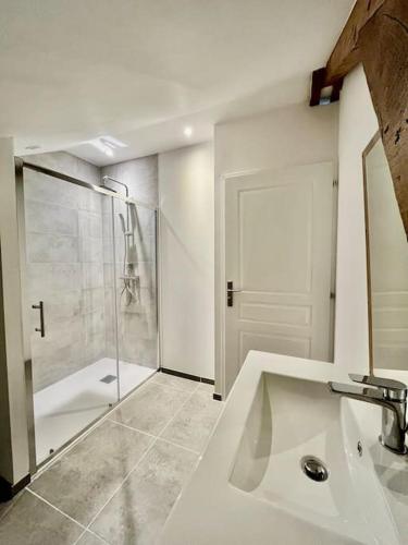 a white bathroom with a shower and a sink at Le Bohème / zone sud - DABNB in Limoges