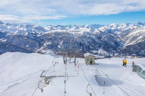 a group of people on a ski lift on a mountain at Villaggio Olimpico in Sestriere