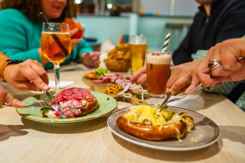 a group of people sitting at a table with plates of food at The People - Strasbourg in Strasbourg