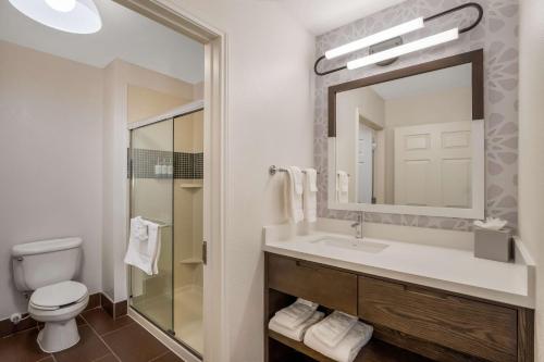 a bathroom with a sink and a toilet and a mirror at Sonesta ES Suites San Diego - Sorrento Mesa in Sorrento