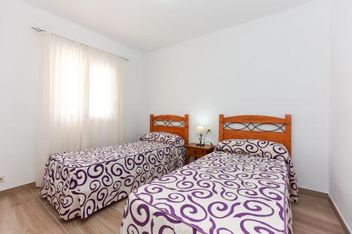 two beds sitting next to each other in a bedroom at Villa Santa Lucia in Denia