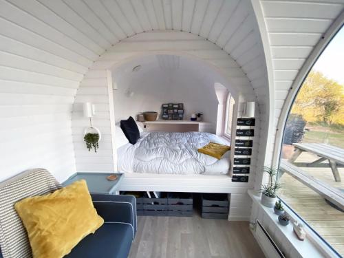 a bedroom with a bed in a small room at Jam First - Lydcott Glamping, Cornish Sea Views in East Looe