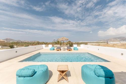 a swimming pool with blue chairs and a swimming poolvisor at Gorgeous Naxos Villa | 3 Bedrooms | Villa Hancock | Beautiful Sea Views and Private Pool | Naxos in Agia Anna Naxos