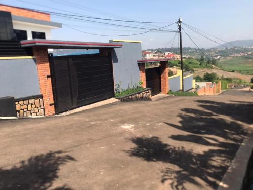 an empty street next to a building with a garage at Muyovu Apartment in Kigali