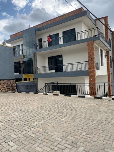 a person standing on the balcony of a building at Muyovu Apartment in Kigali