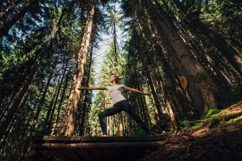 a woman standing in the middle of a forest at Torghele's Wald & Fluh in Balderschwang