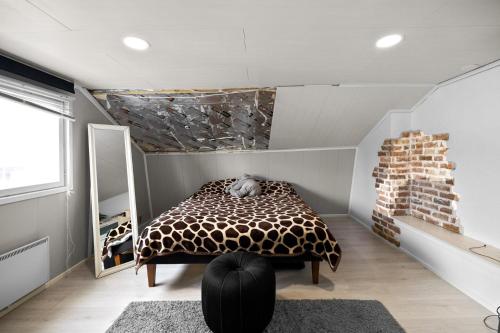 a bedroom with a giraffe print bed in a room at Talo Kerava in Kerava