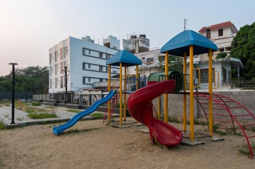 a playground with a red slide at Aafiya lakeview Apartments in Coimbatore